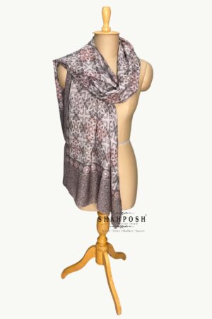 Stole with a geometric and floral pattern in greyish, white, and soft pastel tones.
