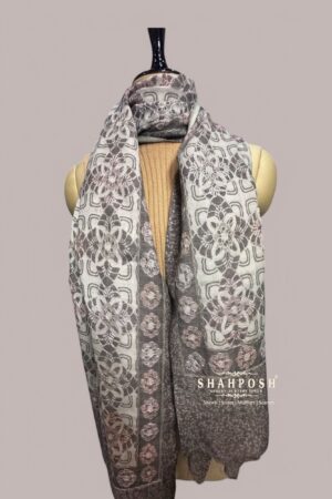 Stole with a geometric and floral pattern in greyish, white, and soft pastel tones.