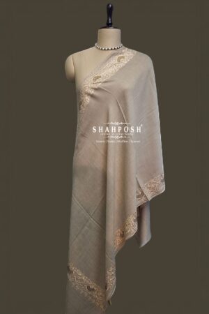 Elegant beige stole with delicate embroidered borders.