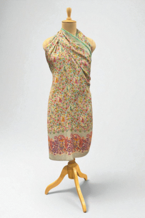 A cream shawl with multicolor paisley Printed and a green-bordered edge, exuding elegance.