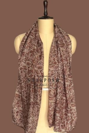 A Shahposh cascade of richly patterned silk scarf in cocoa and cream drapes with sophisticated ease, whispering  luxury.